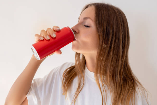 Female drinking cold cola from can