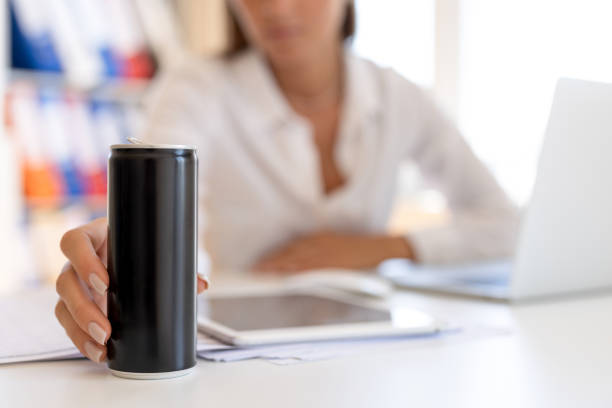 Woman holding energy drink can