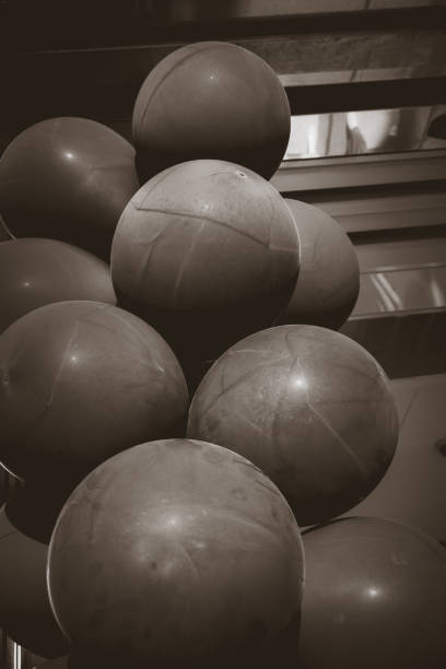 istock Unique arrangement of brown spherical objects stacked together in a modern setting 2187676366