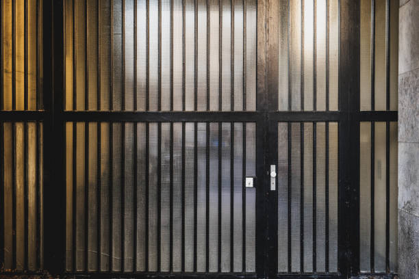 istock Black metal gates with vertical bars in a dimly lit urban environment during the evening 2187676383