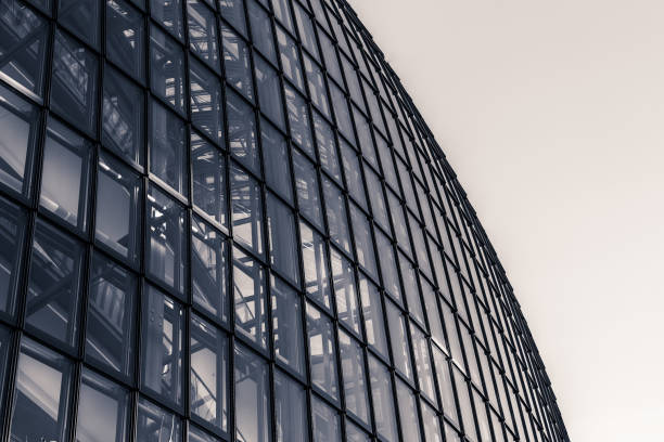 istock Modern architectural structure features geometric lines and glass panels against a light sky in an urban environment 2187676400
