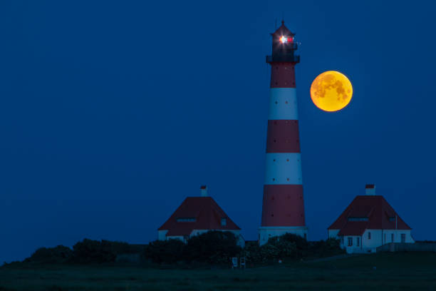 istock Moon at the Westerhever lighthouse 2187679871