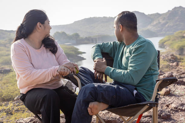 istock Couple spending quality time and Embracing Mountain Serenity with Lake View 2187680272