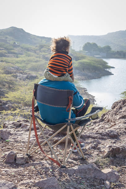 istock Father and Son Bonding on Mountain Top with Lake View 2187680435