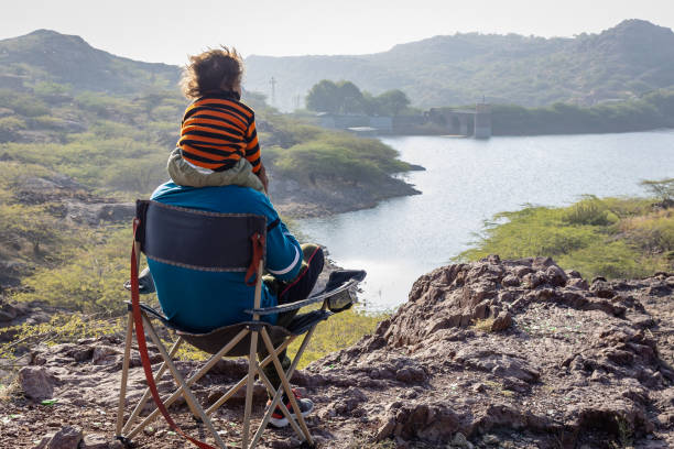 istock Father and Son Bonding on Mountain Top with Lake View 2187680436