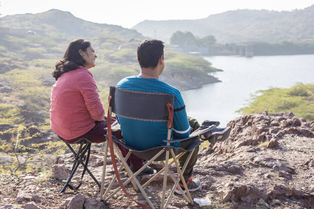 istock Couple spending quality time and Embracing Mountain Serenity with Lake View 2187680437