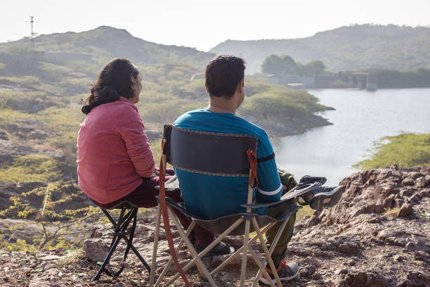 Couple spending quality time and Embracing Mountain Serenity with Lake View