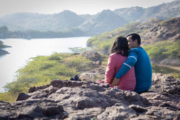 istock Couple spending quality time and Embracing Mountain Serenity with Lake View 2187680483