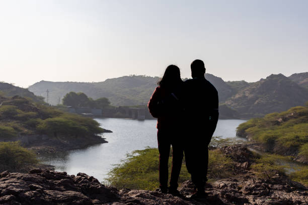 istock Couple spending quality time and Embracing Mountain Serenity with Lake View 2187680485