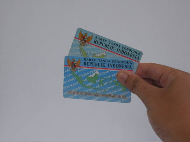 istock Indonesian ID Card (KTP) displayed in hand on a clean white backdrop. 2187681363