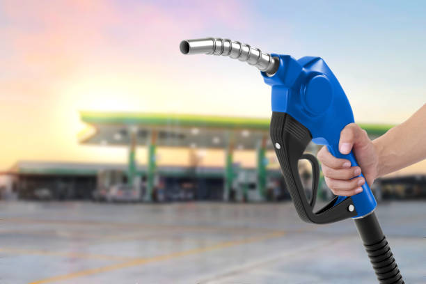 istock Holding a fuel nozzle against with gas station blurred background 2187681632