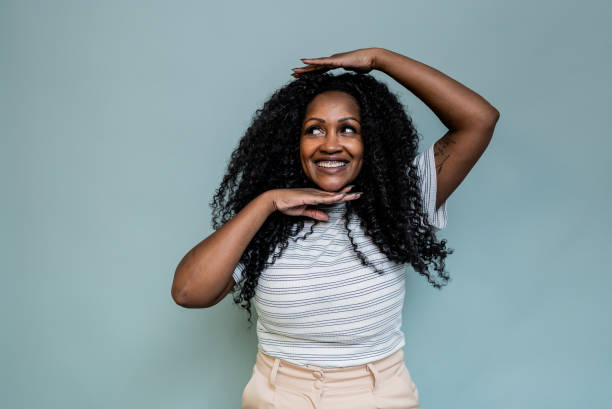 istock Mid adult woman doing a frame on a blue background 2187685459