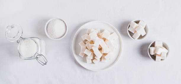istock Alternative choice between lump sugar and granulated sugar on white top view web banner 2187686011