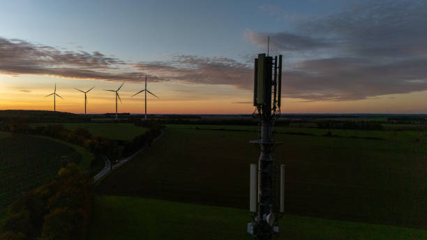 istock Sunset Over Countryside with Wind Turbines and Tower 2187686240