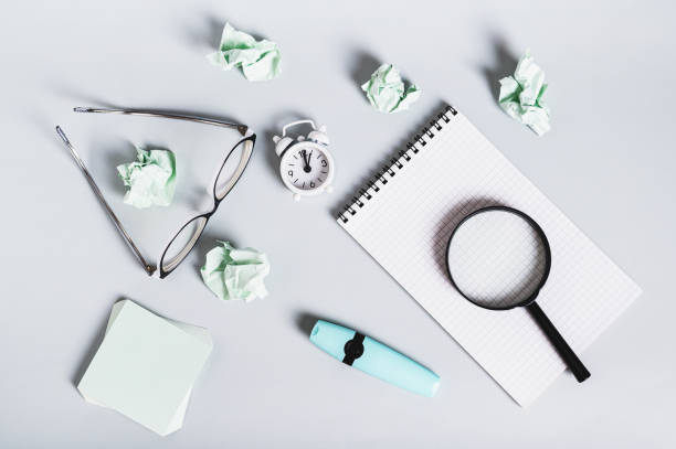 istock Burnout break concept. Notebook, glasses and alarm clock on the desk top view 2187686453