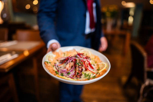 istock Waiter showing a dish at a restaurant 2187686762
