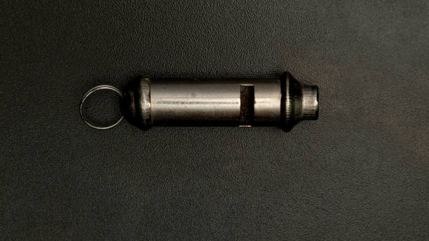 istock Metal whistle lying on a dark background with copy space 2187687322