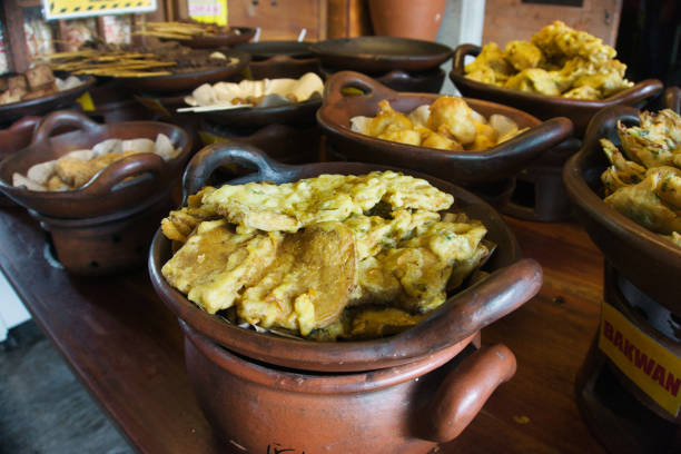 istock Traditional Indonesian Fried Snacks in Rustic Clay Pots on Display 2187689292