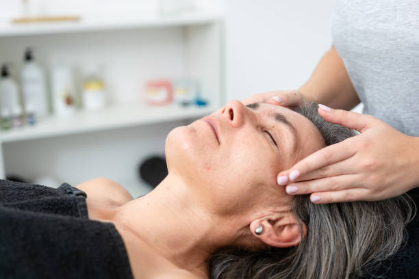 istock Woman receiving a facial massage while at a spa 2187689511