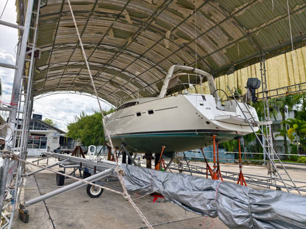 istock A boat is carefully lifted under a covered structure 2187690218