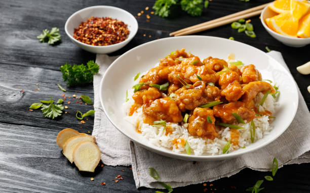 istock Chinese orange chicken with rice and green onion garnish 2187691237