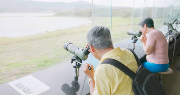 istock asian older couple telescope birding 2187695594