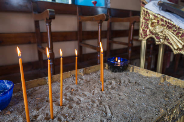 Zakynthos; inside of an orthodox chapel with focus on the burning candle. In the background some icon`s