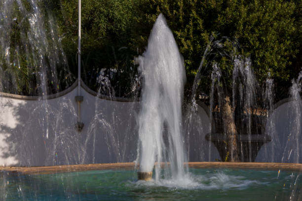 istock Water drops splashing from a fountain in a park 2187699394