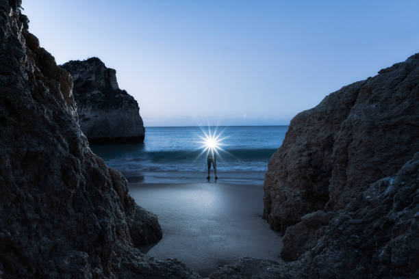 istock Man wearing illuminated headlamp and standing on beach 2187710182