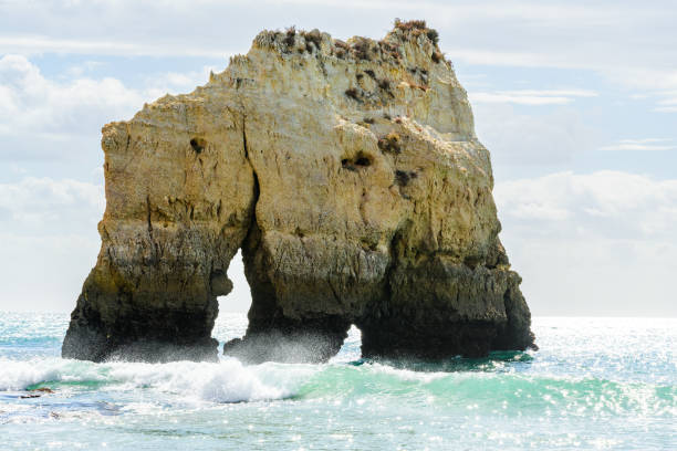 Large scale rock formation in sea, Alvor, Algarve, Portugal, Europe