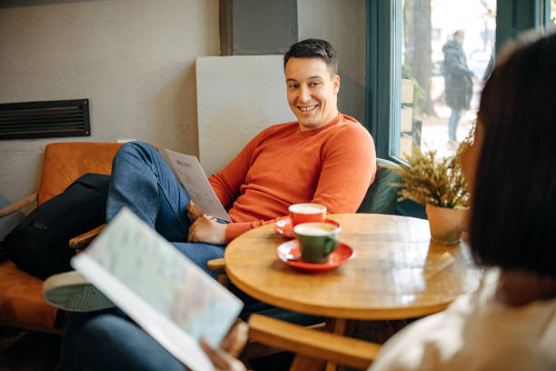 Loving couple are looking at a travel flyer