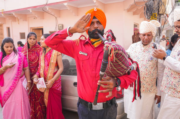 Beawar, Rajasthan, India, November 29, 2024: Artist of punjabi band perform in a chariot procession of 28-year-old software engineer Harshali Kothari during her initiation ceremony in Beawar. Harshali quits job with INR 3.2 million annual package to become sadhvi (jain nun). Beawar residents Ashok Kothari and Usha Kothari's daughter Harshali decided not to get married and also adopted the vow of celibacy. She will be leaving her family and other relations to adopt simple life of a sadhvi on December 3.