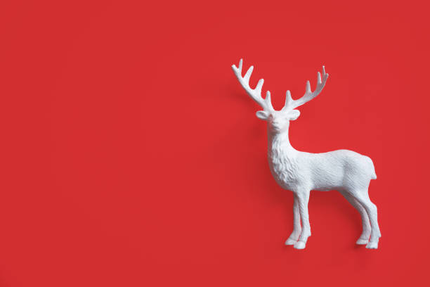 istock Decorative white deer figure on red background with space for text. 2187713675