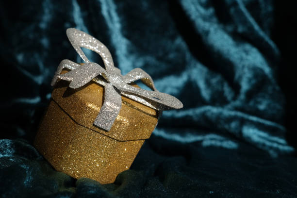 istock Shiny gift box on a glamorous velvet background 2187713684
