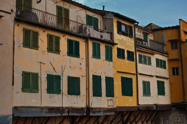Side view of colorful house facades located at famous Ponte Vecchio bridge and Arno river in Florence, Tuscany, Italy, Europe