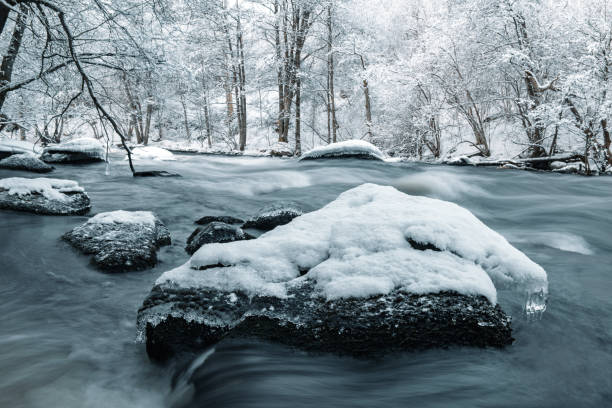 Water flowing in winter river, Sweden
