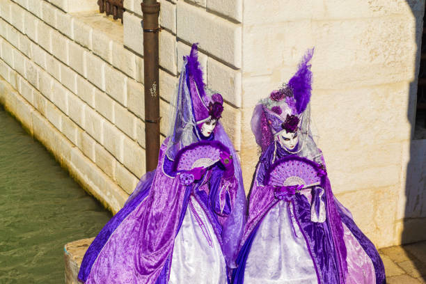 Venice, Italy - February 8, 2024: The Carnival of Venice (Italian: Carnevale di Venezia) is an annual festival held in Venice, Italy, famous throughout the world for its elaborate costumes and masks. \nThe Carnival ends on Shrove Tuesday (Martedì Grasso or Mardi Gras), which is the day before the start of Lent on Ash Wednesday (February-March).\nThe Carnival traces its origins to the Middle Ages, existing for several centuries until it was abolished in 1797. The tradition was revived in 1979, and the modern event now attracts approximately 3 million visitors annually.
