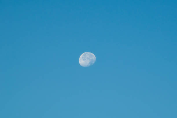 Moon seen in the morning against a clear blue sky