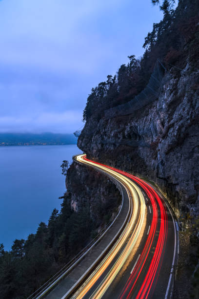 istock The spetacular motorway on cliff with traffic light trail in the evening 2187718299
