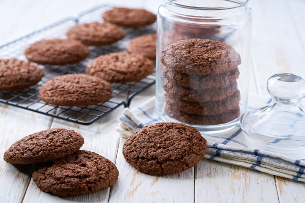 istock Glass jar with american chocolate cookies on a white table. 2187722531