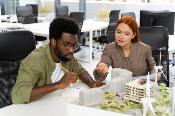 istock Two colleagues working in the office on a new sustainable project 2187723065