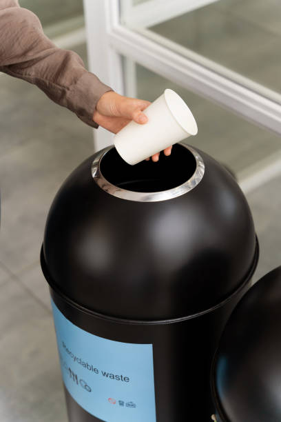 istock Woman choosing a proper container for throwing paper cup 2187723219