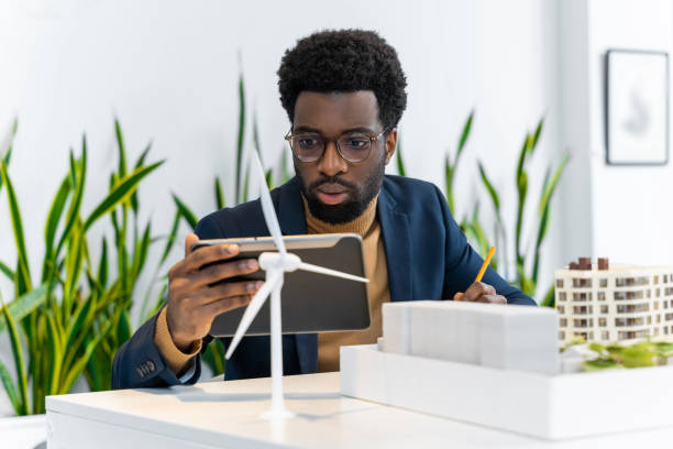 istock African american architect working on a wind farm project and looking involved 2187723249