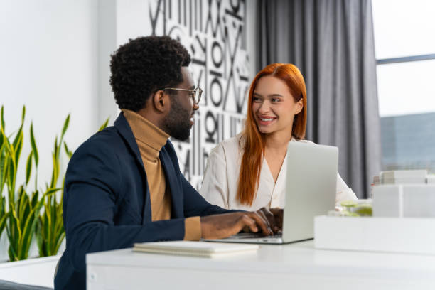 istock Two colleagues discussing a new project in the office and looking excited 2187723306