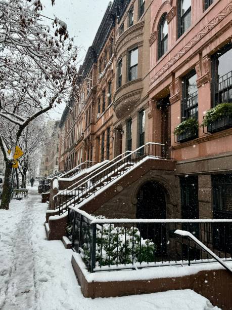 istock Brownstone-lined street in Harlem in the snow 2187723476