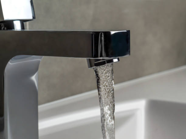 istock Chrome faucet with running water 2187726426