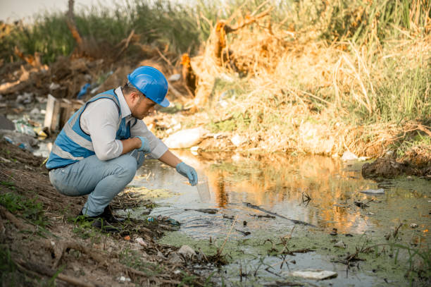 istock Water resources engineers inspect the quality of a canal in a community filled with garbage. 2187727310