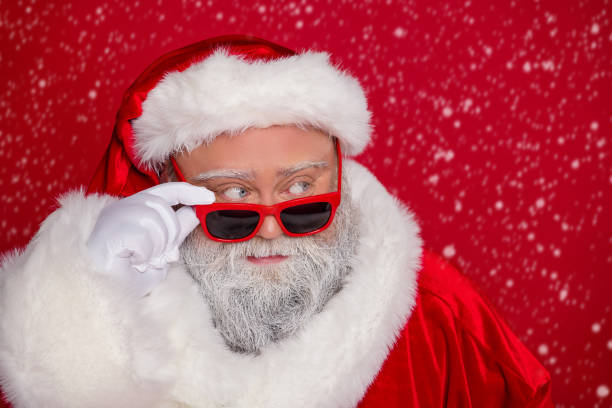 istock Portrait of attractive funny curious Santa touching specs north pole thinking deciding isolated over vivid red color background 2187728089