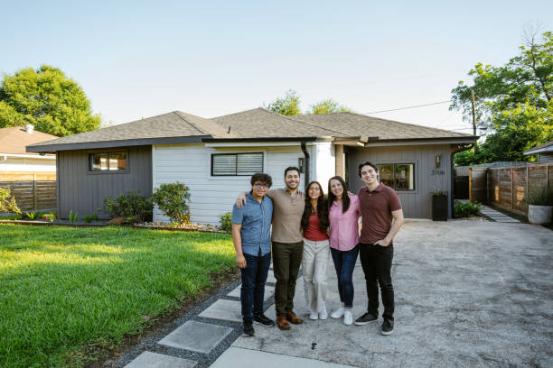 istock Multiegeneration amily proudly posing in front of newly bought house 2187734605