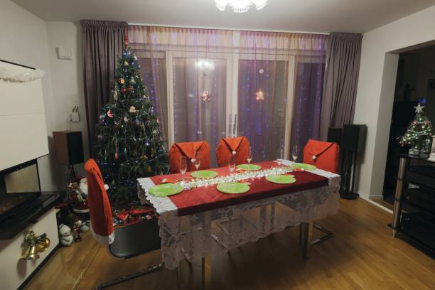 istock View of an interior Christmas dinner table with festive decorations, a lit Christmas tree, and a cozy atmosphere in a fireplace room. Sweden. 2187736934